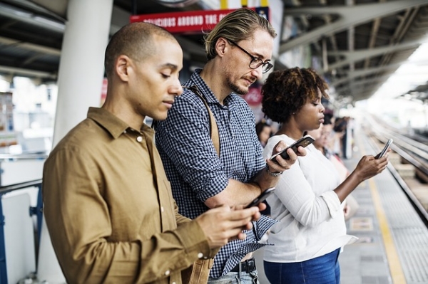 a picture of three people using their phone