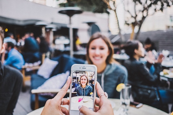 A lady taking a picture of another lady