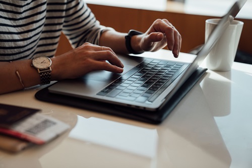 A man typing on Laptop's Keyboard