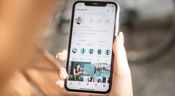 A picture of a lady using Instagram on her iPhone