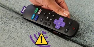 A lady holding a Roku remote