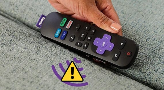 A lady holding a Roku remote