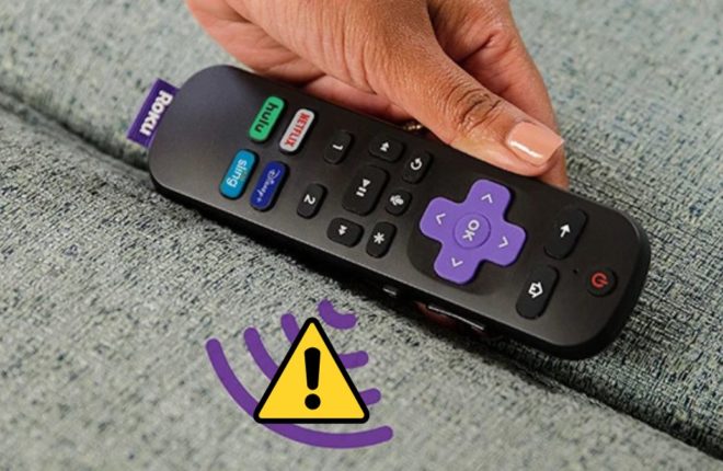 A lady holding a Roku remote