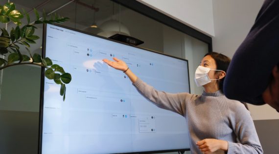 Woman presenting using a large screen