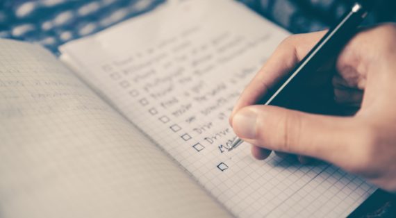 Person writing on notebook