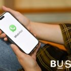 A person launches WhatsApp on his phone while holding it infront