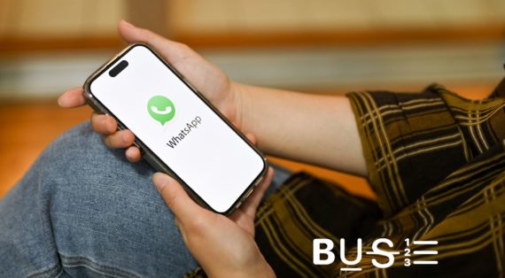 A person launches WhatsApp on his phone while holding it infront